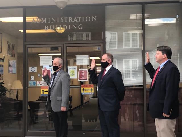 Board members Marcus Edgy, John Madala and Jerry Mancil are sworn in by Judge Stephen Kelley.