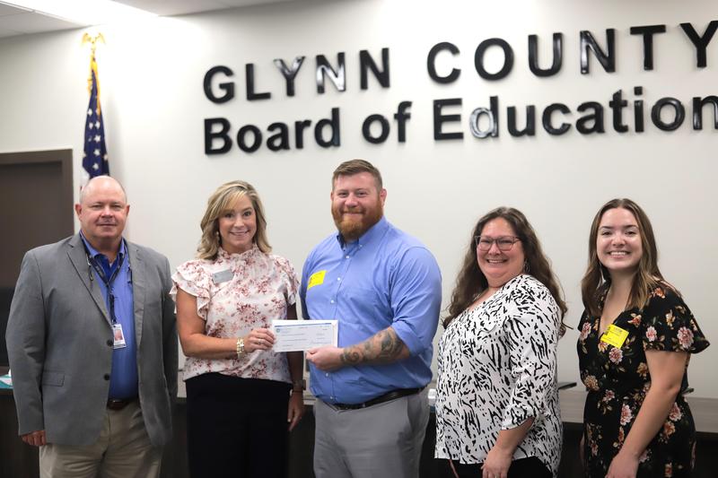 Scott Spence, superintendent of Glynn County Schools, from left, stands with school nutrition director Shelley Daniel, Eat’n Together co-founder Alec Eaton, nutrition department bookkeeper Marie Beverley and local grant writer Haleigh Jinkins.