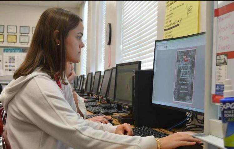 Miles Young, editor in chief for Glynn Academy\'s yearbook staff, works on this year\'s issue. The school\'s 2022 High Tide yearbook won a first-place ranking from the American Scholastic Press Association and was one of four to win \"Most Outstanding High School Yearbook\" in the nation.