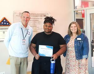 Needwood Middle student Kenny Anderson with district administrators.