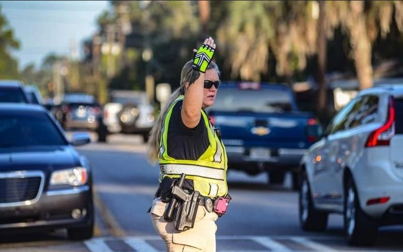 Glynn County Schools police officer Brandy Putnam directs heavy traffic on Parkwood and parents line up on the first day of school at Goodyear Elementary School.