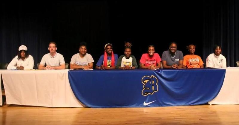 Brunswick High’s Titus Washington, Sebastian Hutchinson, Shakaylan Pinkston, Shamya Flanders, Dariana Johnson, JaMya West, Shane Jackson, Taniyah Battle and Camarion Johnson pose for a photo during a signing ceremony.