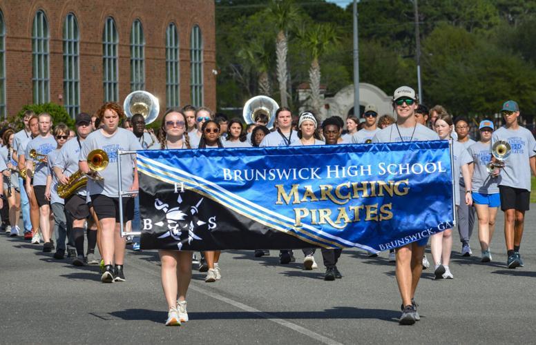 The Brunswick High Marching Pirates march behind their shiny banner as they practice for the upcoming National Cherry Blossom Festival.