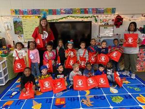 Students at the FACES Pre-K Center holding their Take 5 bags.