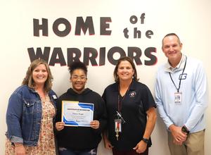 Needwood Middle student Chelsea Wright with school and district administrators.