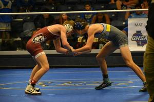 A Brunswick High wrestler grapples for wrist control against a South Effingham wrestler.