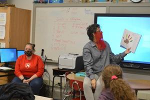 Gena Churchwell, a Glynn Academy teacher, shared with students Friday a book they created titled \"I Am Thankful For.\"