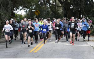 Runners in the Super Dolphin Day 10K in 2020 race head down Beachview Drive.