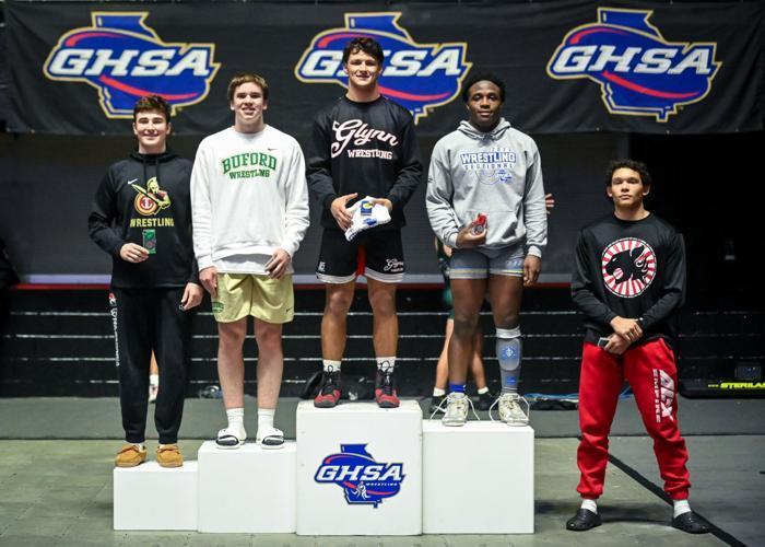 Glynn Academy\'s Jackson Wakeland and Brunswick High\'s Leon Charlton stand at the podium after finishing 1-2 wrestle in the 182-pound weight class at the Class 6A Traditional Wrestling State Championship in Macon.