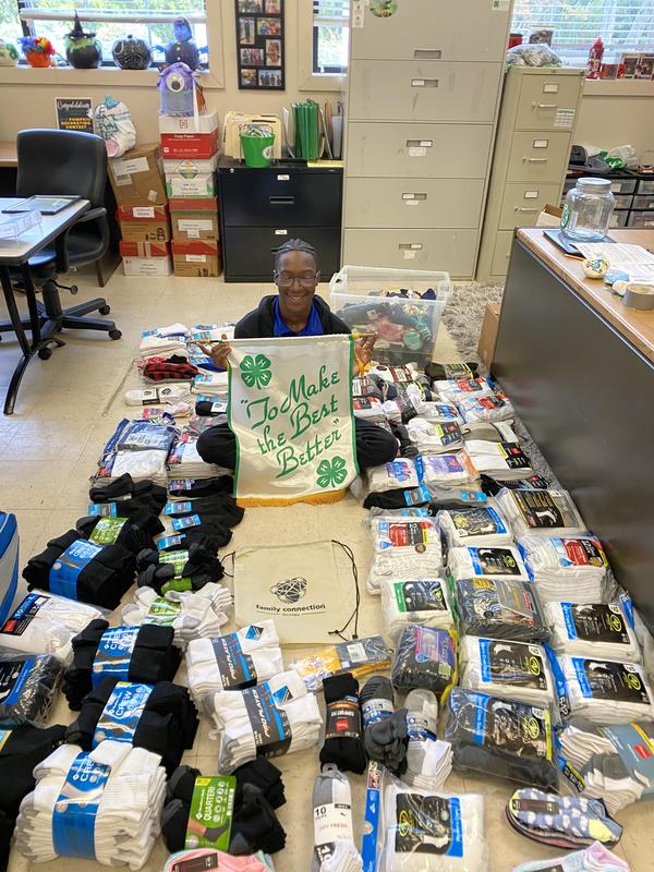 Chanthony Andrews Jr. with some of the donations from his most recent \'Socktober\' campaign.