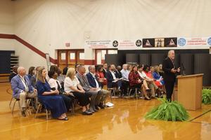 State Superintendent Richard Woods with district and school leaders at a special banner presentation.