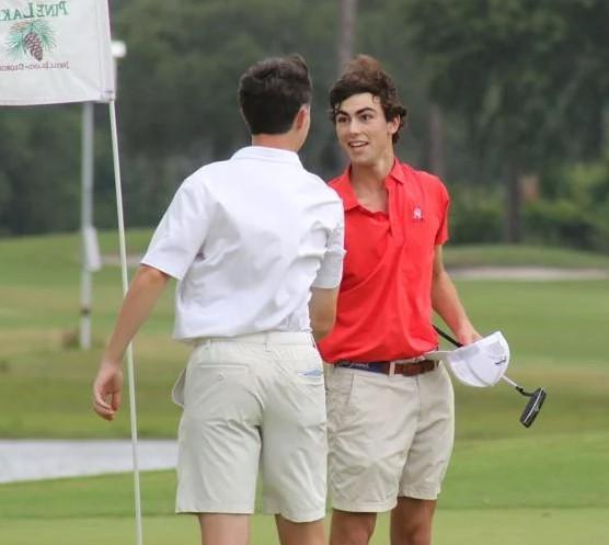 Glynn Academy\'s Shep Davenport shakes hands with a competitor after finishing up his first round at the GHSA Class 6A Boys State Golf Championships at the Jekyll Island Golf Club.