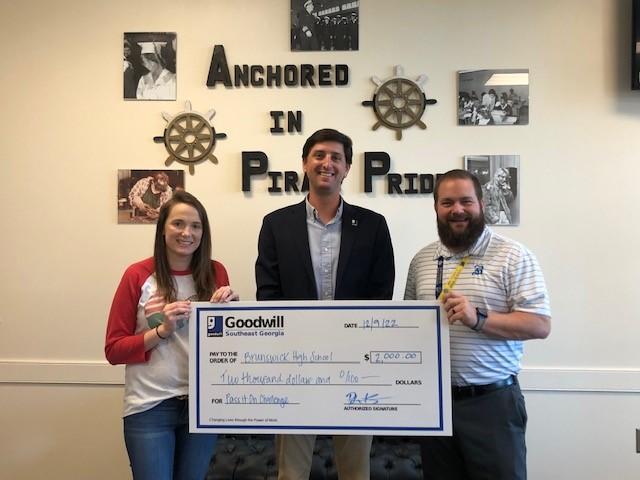 BHS Principal Slade Turner, right, with representatives of Goodwill Southeast Georgia.