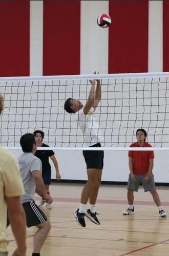 Glynn Academy\'s Daniel Smiley sets during a boys volleyball practice.