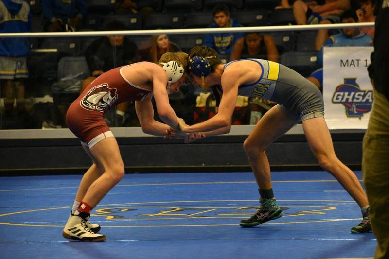 A Brunswick High wrestler grapples for wrist control against a South Effingham wrestler.