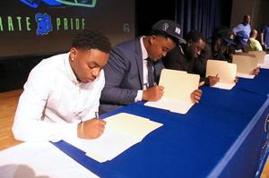 Brunswick High football players sign on national signing day.