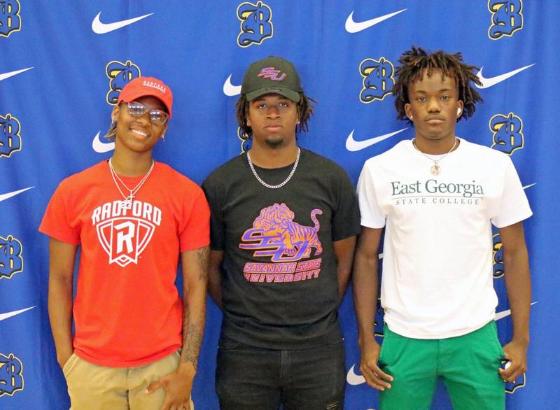 Brunswick High\'s Makalia Brown, Xavier Bean and Kamori Towns pose for a photo following a signing ceremony held in the school\'s gymnasium Friday.