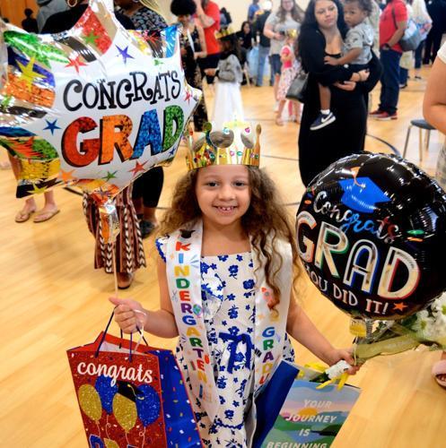 Delilah Brown holds onto balloons and other congratulatory items after she graduated from Altama Elementary kindergarten.