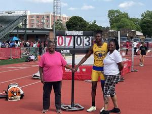 Brunswick High\'s Riyon Rankin poses for a photo with his family after breaking the high jump record at the GHSA state meet in Rome.