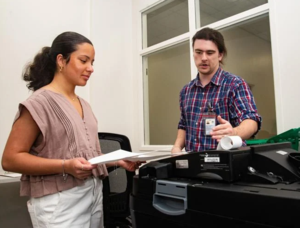 Sophia Bravo feeds marked test ballots into a combined scanner and ballot box as she participates in Golden Isles Government Immersion Day.