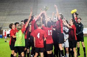 Glynn Academy lifts its 15th Region championship trophy after its 1-0 win over Osborne in the second round of the playoffs.