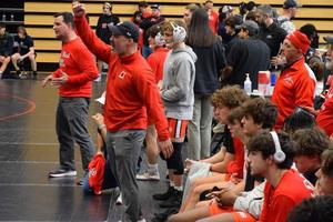 Glynn Academy head coach Ryan Aflau reacts during a match at the GHSA Class 6A Team Duals Wrestling State Championships on Jan. 20 in Cumming.