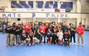 Glynn Academy wrestlers pose for a photo after winning the traditional Region 1-5A championship on Feb. 1, 2025 at Brunswick Square Garden.