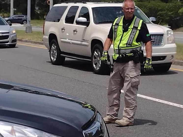 GCSS officer Joe Owens directs traffic Thursday at Golden Isles Elementary. It was his last day on the job.