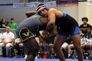 Brunswick High\'s Anthony Lowe competes against a Valdosta High wrestler during the semifinals of the Class 6A GHSA Team Dual Wrestling Championship at Brunswick Square Garden.