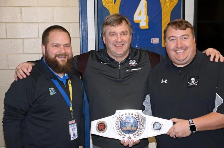 Georgia football coach Kirby Smart, center, poses for a photo with Brunswick High School principal Slade Turner and football coach Garrett Grady.