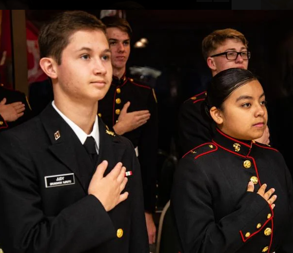 Brunswick High Navy Junior ROTC cadet Nathan Judy, left, and Glynn Academy Marine Junior ROTC cadet Ingrid Avila-Hernandez are shown during the Pledge of Allegiance at the two ROTC\'s joint military ball at Epworth by the Sea.