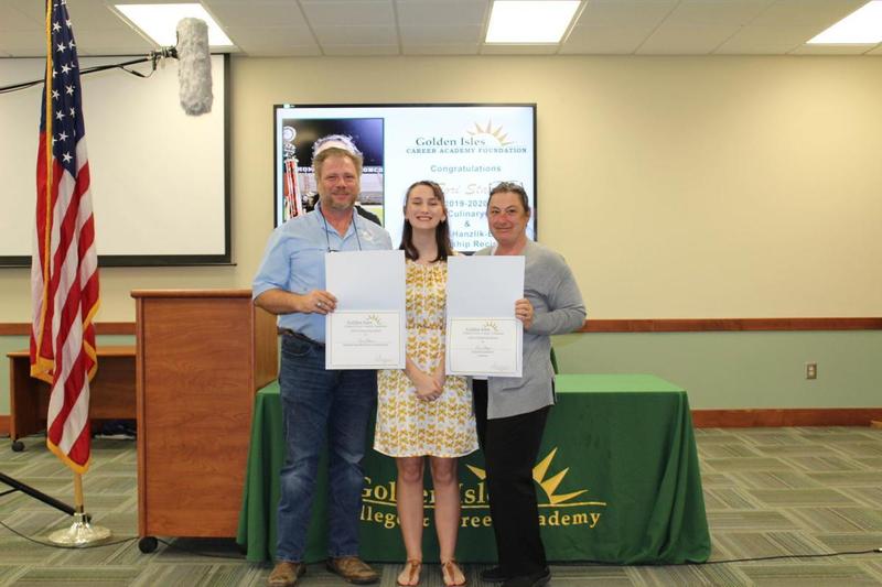 Tori Staat, a recent Glynn Academy graduate and Golden Isles College and Career Academy culinary student, stands with her parents at a recent scholarship ceremony at GICCA.