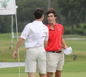 Glynn Academy\'s Shep Davenport shakes hands with a competitor after finishing up his first round at the GHSA Class 6A Boys State Golf Championships at the Jekyll Island Golf Club.