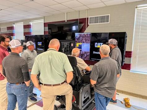 Construction Instructor Jeff Holland (Green Shirt) attends a state-wide training on the new Caterpillar Motion Platform Simulators in June 2023.   GICCA received a $417,000 grant from the Georgia Department of Education to purchase four of the simulators for the 2023-2024 school year.