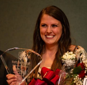 Taylor Priest holds her trophy and flowers after she was named Glynn County Teacher of the Year.