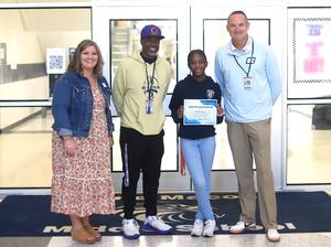 Jane Macon Middle student Brielle Curry with school and district administrators.