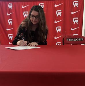 Glynn Academy senior Allie Mason smiles as her mother Sherry Mason takes her picture as she signs a future Georgia educator intent letter Tuesday during a ceremony in the Glynn Academy cafeteria.