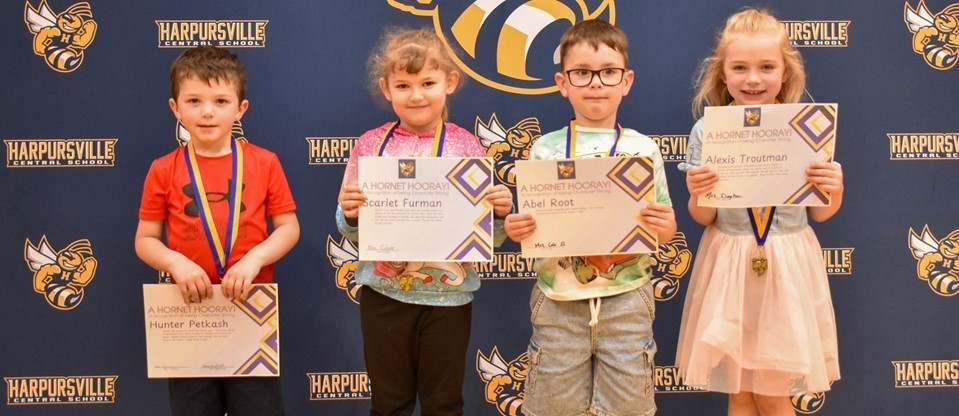 four young students with awards