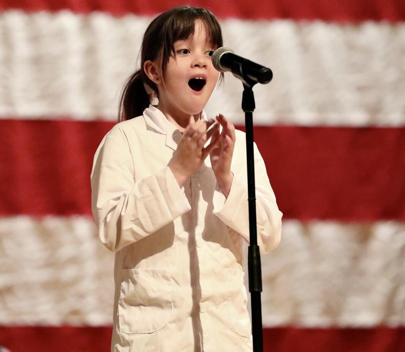 Student who won spelling bee with excited face