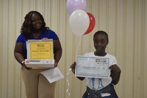 Makayla Burroughs, a fifth grade student at Harry E. James, stands with her winnings after being named a Better Future Fund Winner on April 17.