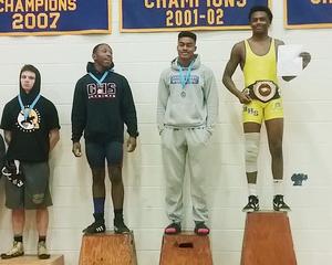 Jacen Fowlkes on award podium.