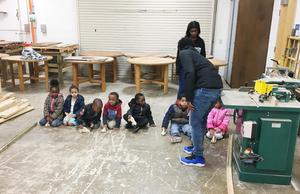 Carpentry students teach WLC students woodworking.