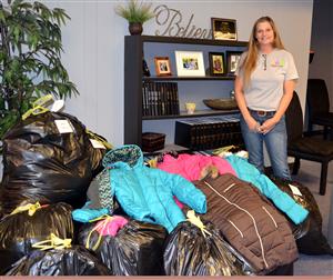 Woman with donated coats 