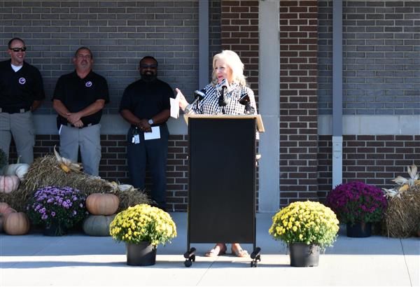 Woman stands at podium