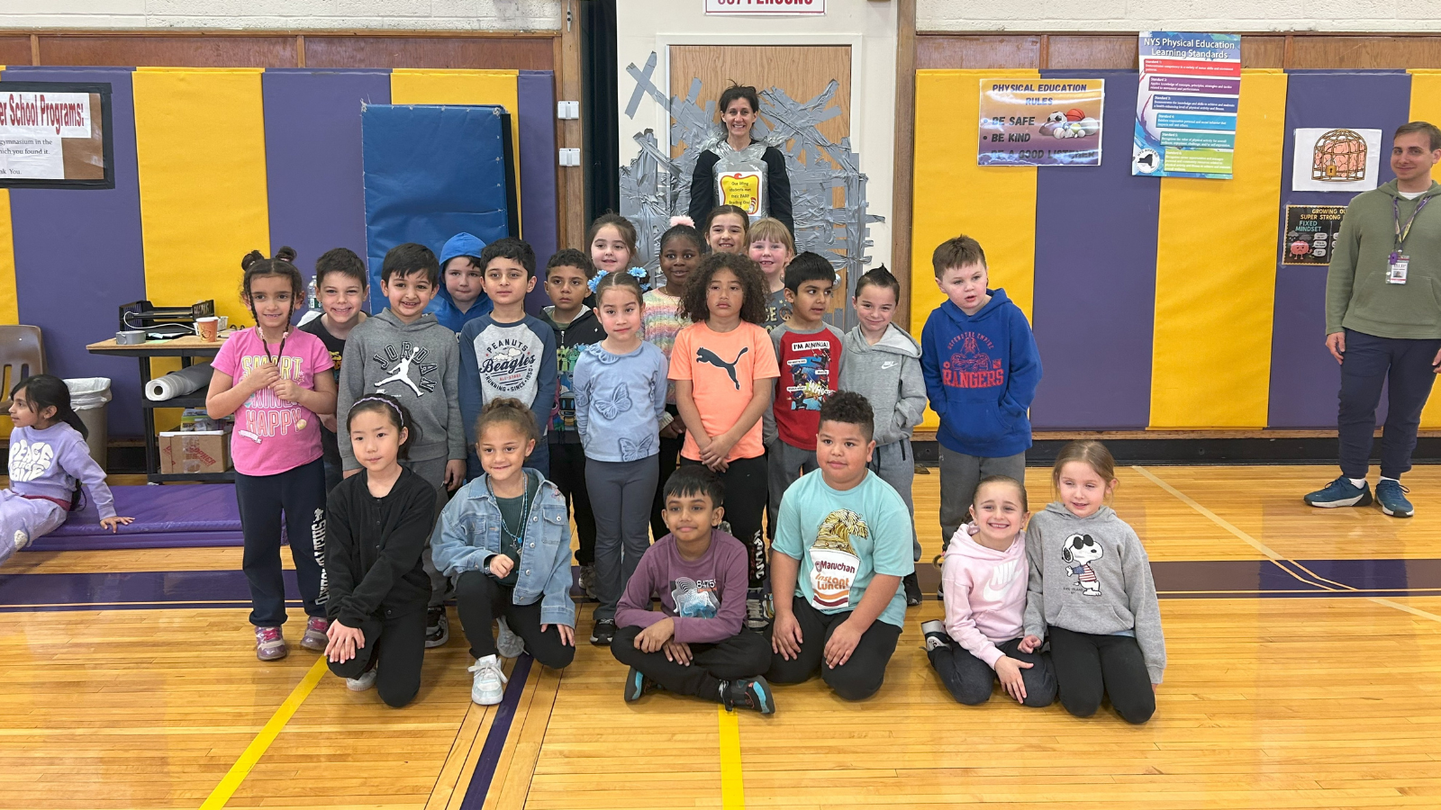 Principal Catherine Glaser duct taped to wall