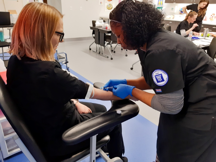 A student drawing blood on another student