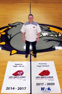 Athletic Trainer, Owen Iseminger with Safe Sport Distinction Award Banners