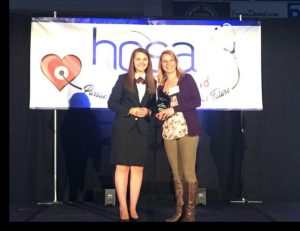 Lawrence receive award on stage at HOSA conference
