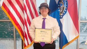 KHS junior Alex Walter poses with a certificate after winning a Platte-Clay Electric Cooperative essay contest.