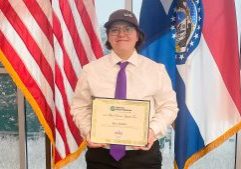 KHS junior Alex Walter poses with a certificate after winning a Platte-Clay Electric Cooperative essay contest.